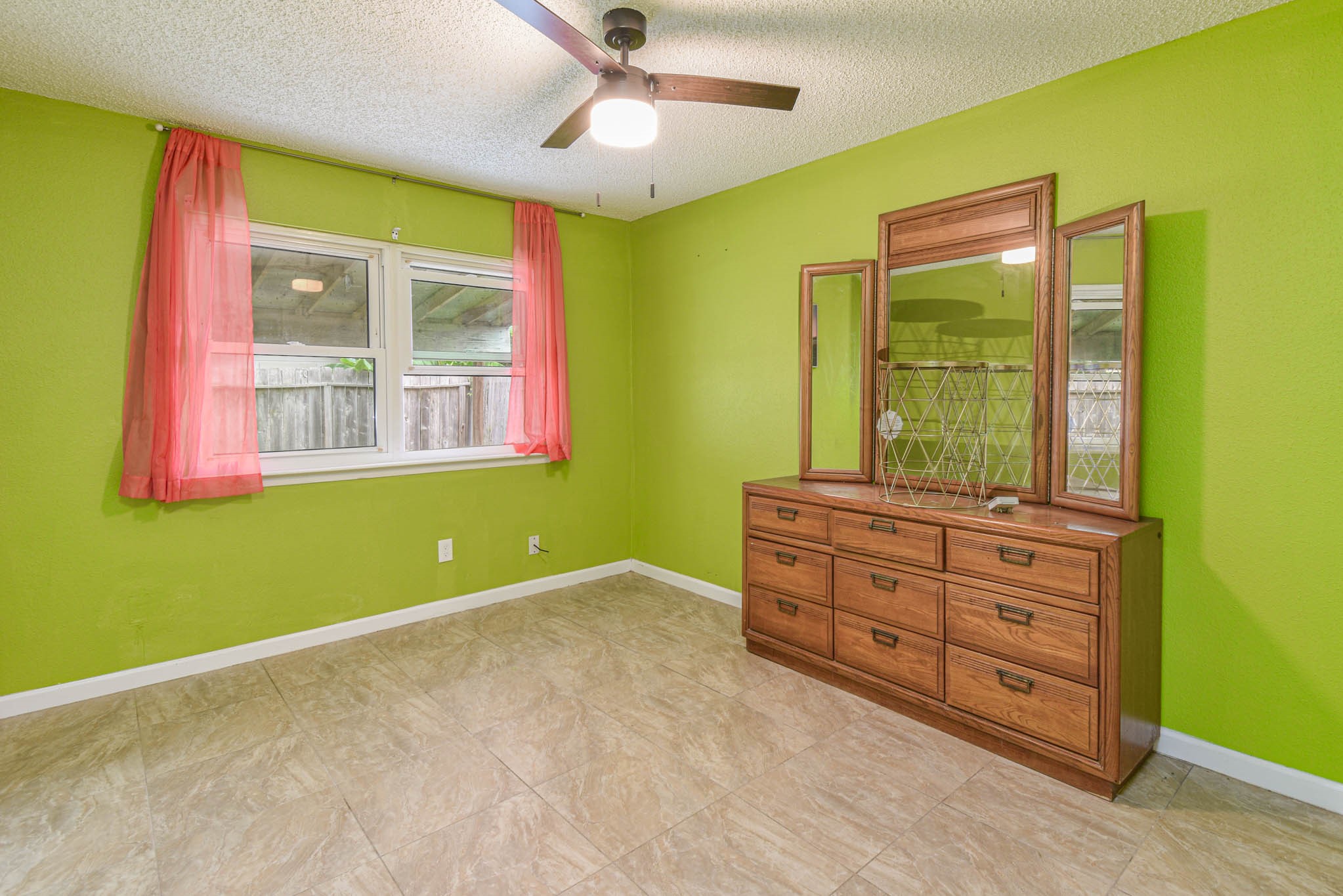 12054 Plumpoint Drive Houston, TX 77099 - Photo 16 of 24 a room with window and ceiling fan