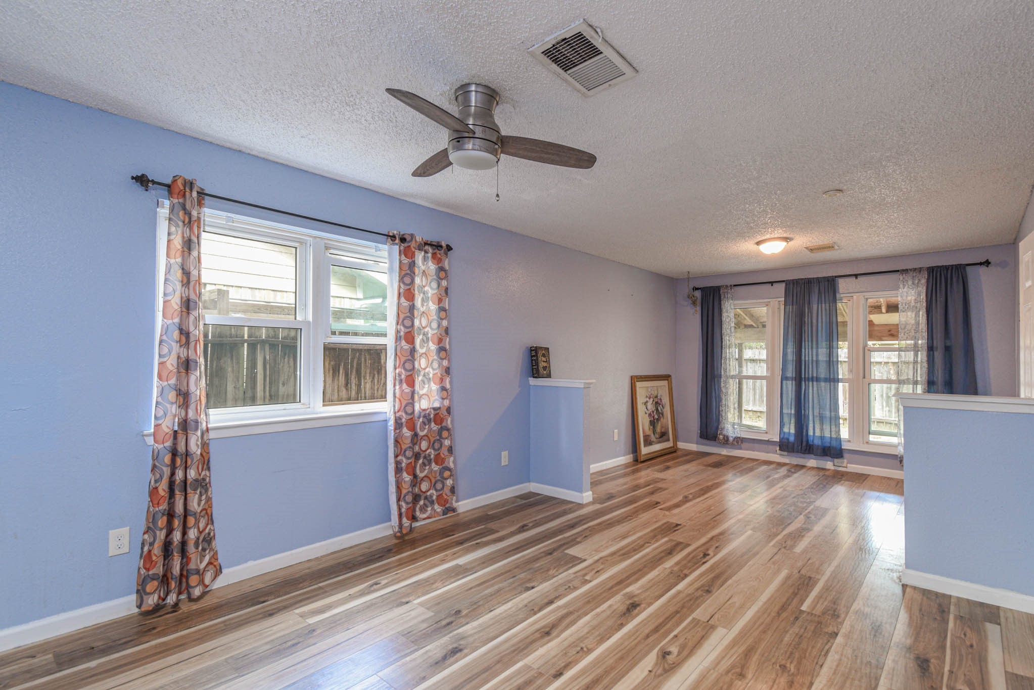 12054 Plumpoint Drive Houston, TX 77099 - Photo 18 of 24 a view of empty room with wooden floor and fan