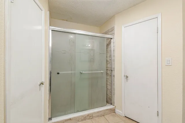 a bathroom with a granite countertop toilet sink and mirror