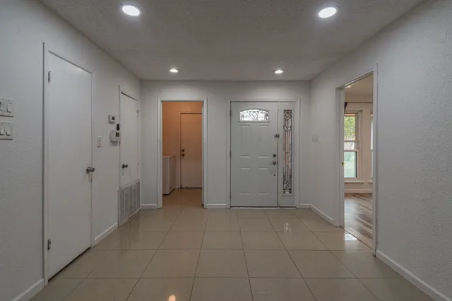 a view of an empty room with glass door