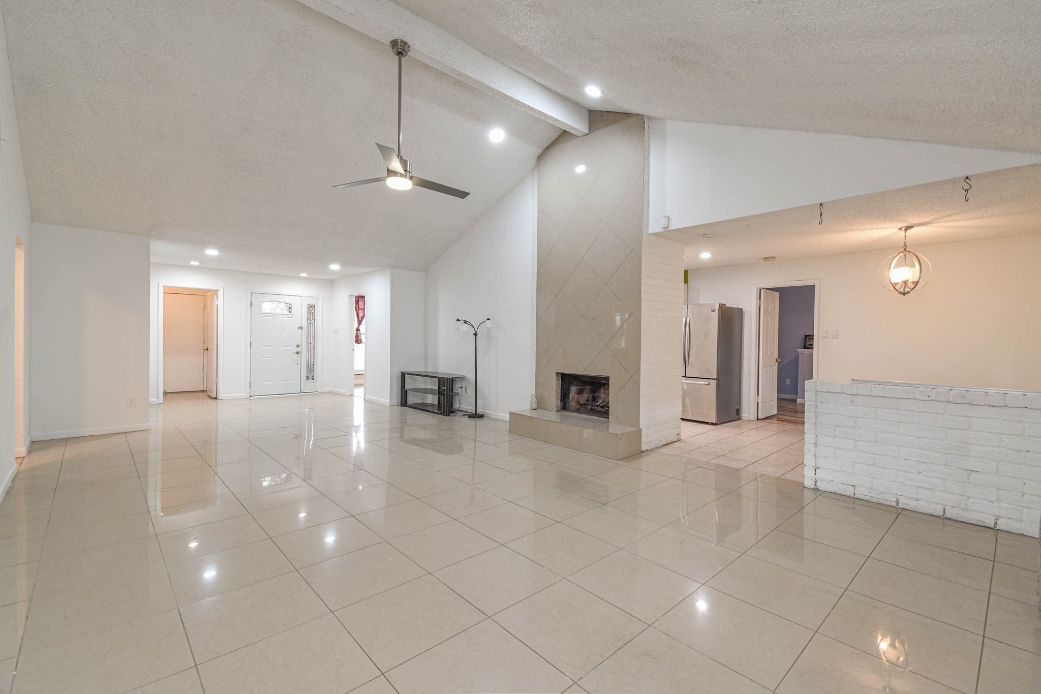 12054 Plumpoint Drive Houston, TX 77099 - Photo 6 of 24 a view of a hallway with chandelier and entryway