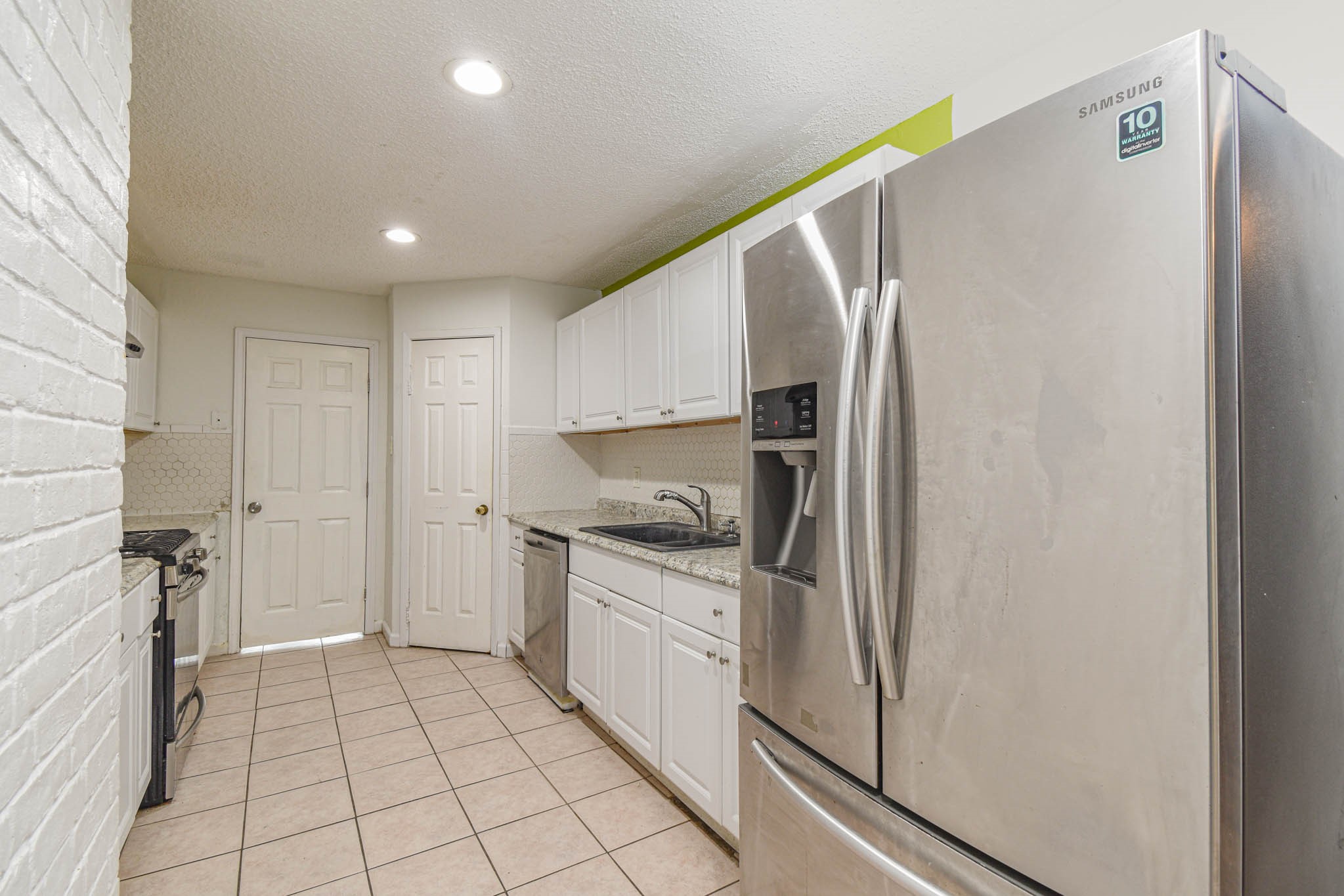 12054 Plumpoint Drive Houston, TX 77099 - Photo 10 of 24 a kitchen with stainless steel appliances granite countertop a refrigerator and a stove