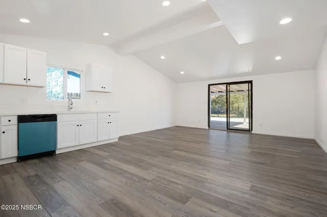 a view of a kitchen with a sink and a window