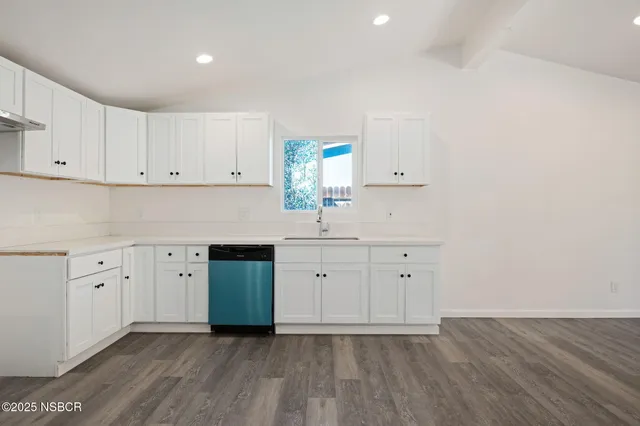 a kitchen with cabinets a sink and dishwasher