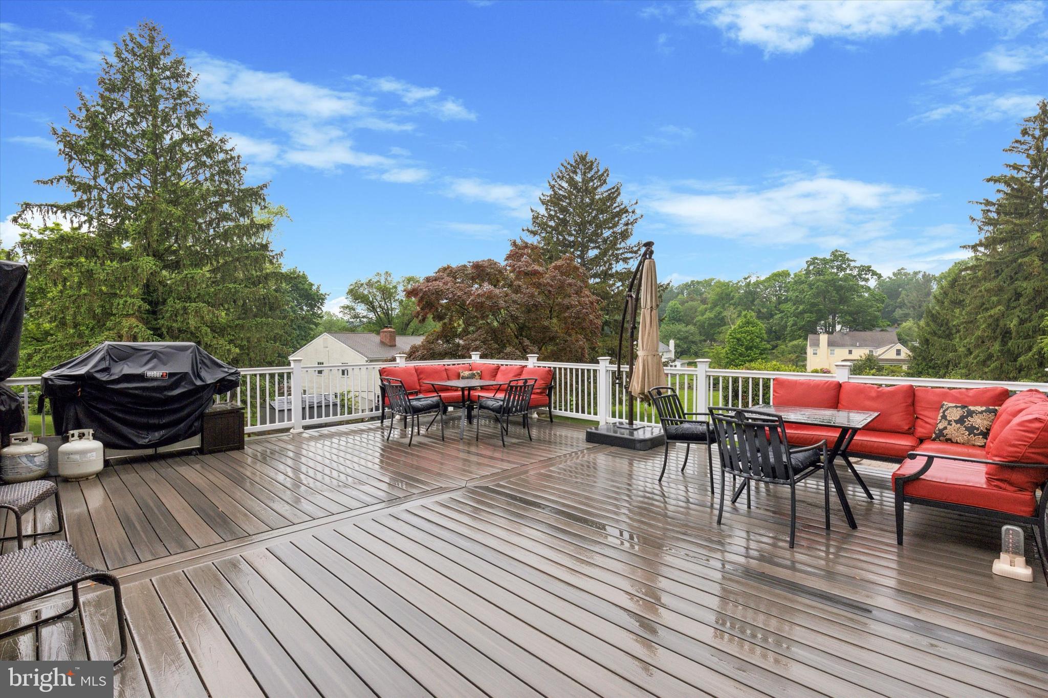 802 Upper Gulph Road Wayne, PA 19087 - Photo 18 of 45 a view of a roof deck with table and chairs with wooden floor and fence