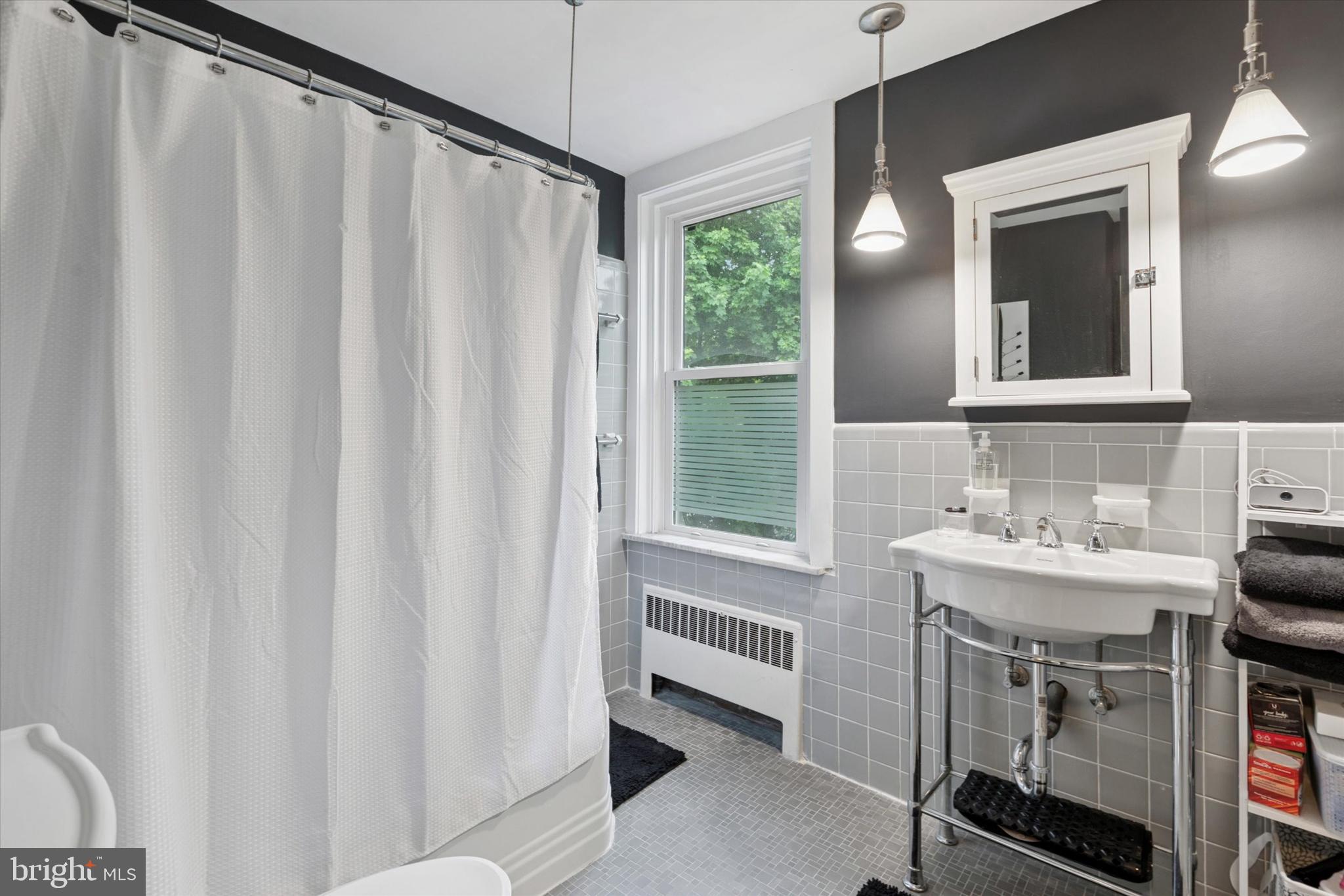 802 Upper Gulph Road Wayne, PA 19087 - Photo 26 of 45 a bathroom with a sink a mirror and a shower curtain