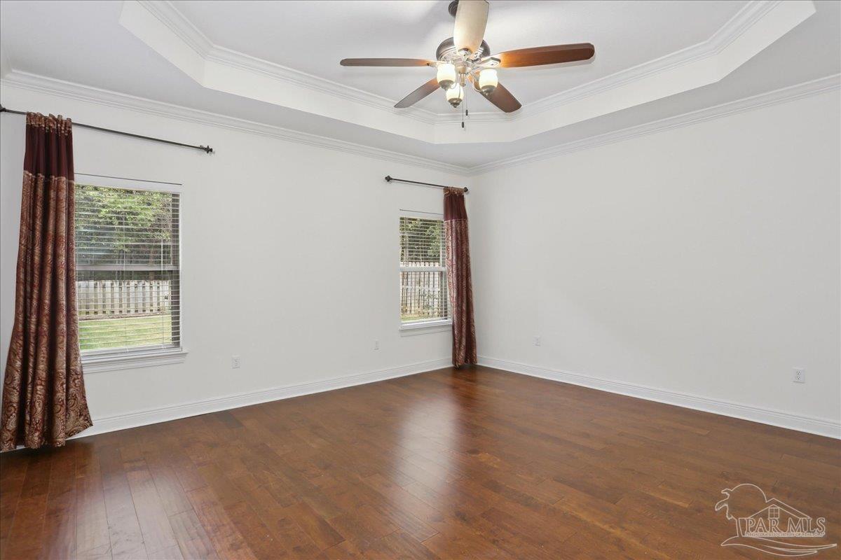 8414 Foxtail Loop Pensacola, FL 32526 - Photo 20 of 61 an empty room with wooden floor chandelier fan and windows