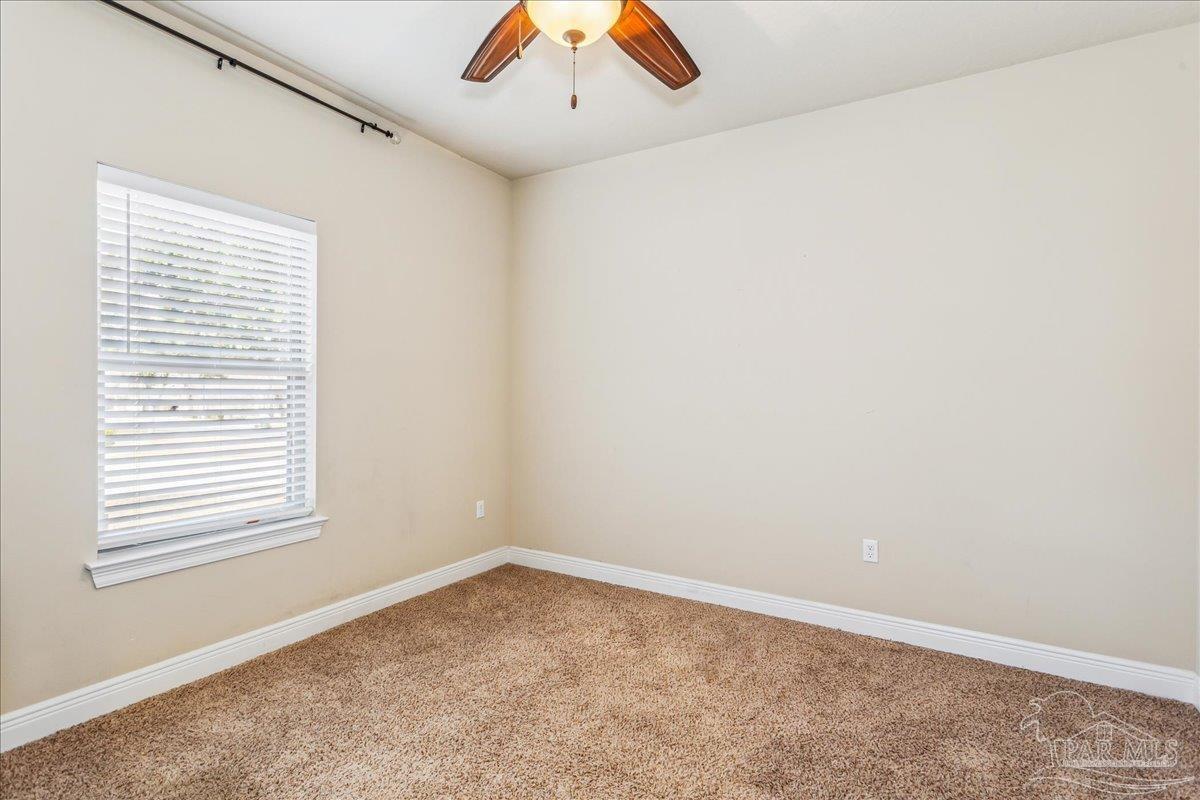 8414 Foxtail Loop Pensacola, FL 32526 - Photo 31 of 61 an empty room with a window and a ceiling fan