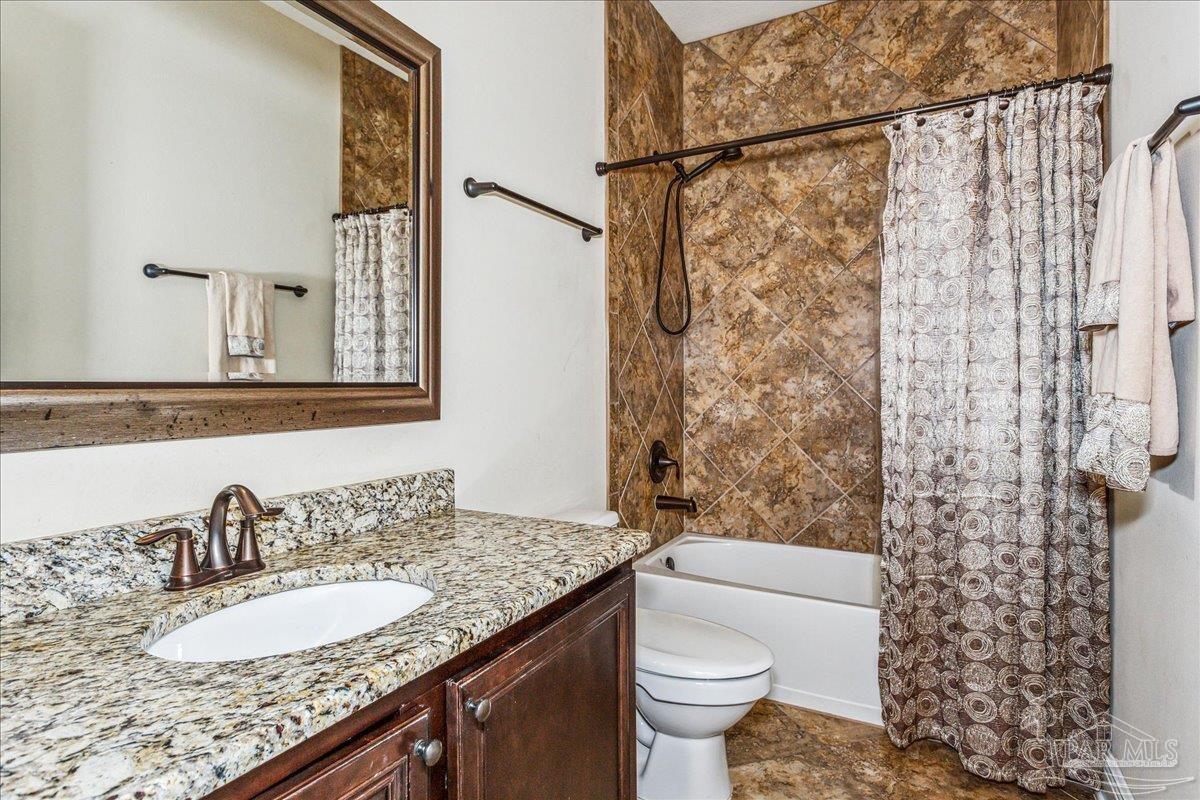 8414 Foxtail Loop Pensacola, FL 32526 - Photo 35 of 61 a bathroom with a granite countertop sink and a mirror