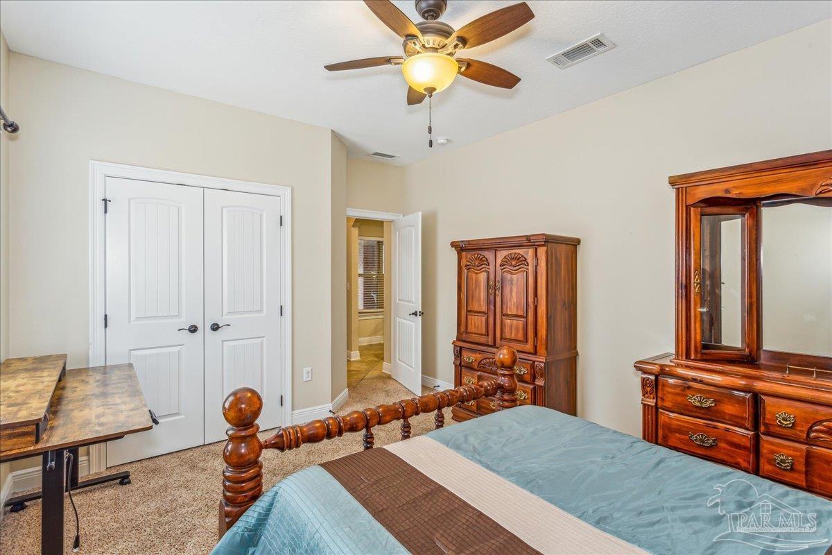 8414 Foxtail Loop Pensacola, FL 32526 - Photo 39 of 61 a bedroom with a bed and a chandelier