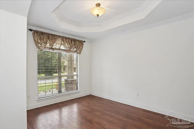 a living room with furniture ceiling fan and a flat screen tv