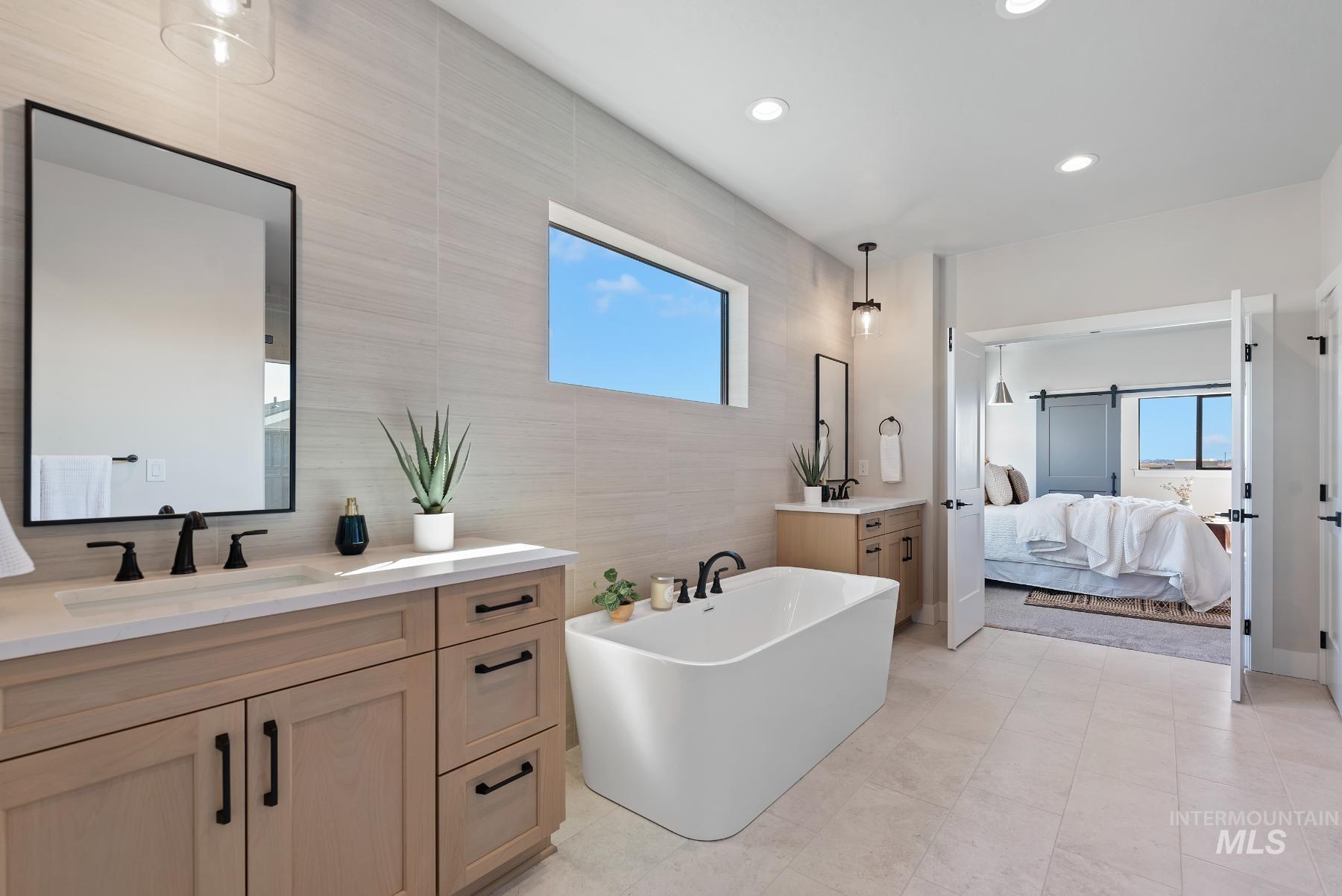 8410 West Graye Street, Unit ALPINE Meridian, ID 83646 - Photo 12 of 45 Open-concept living area featuring wood-finish flooring and a two-story ceiling