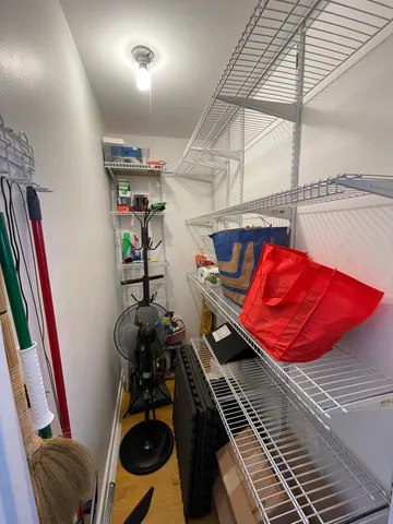 a utility room with dryer washer and a view of kitchen