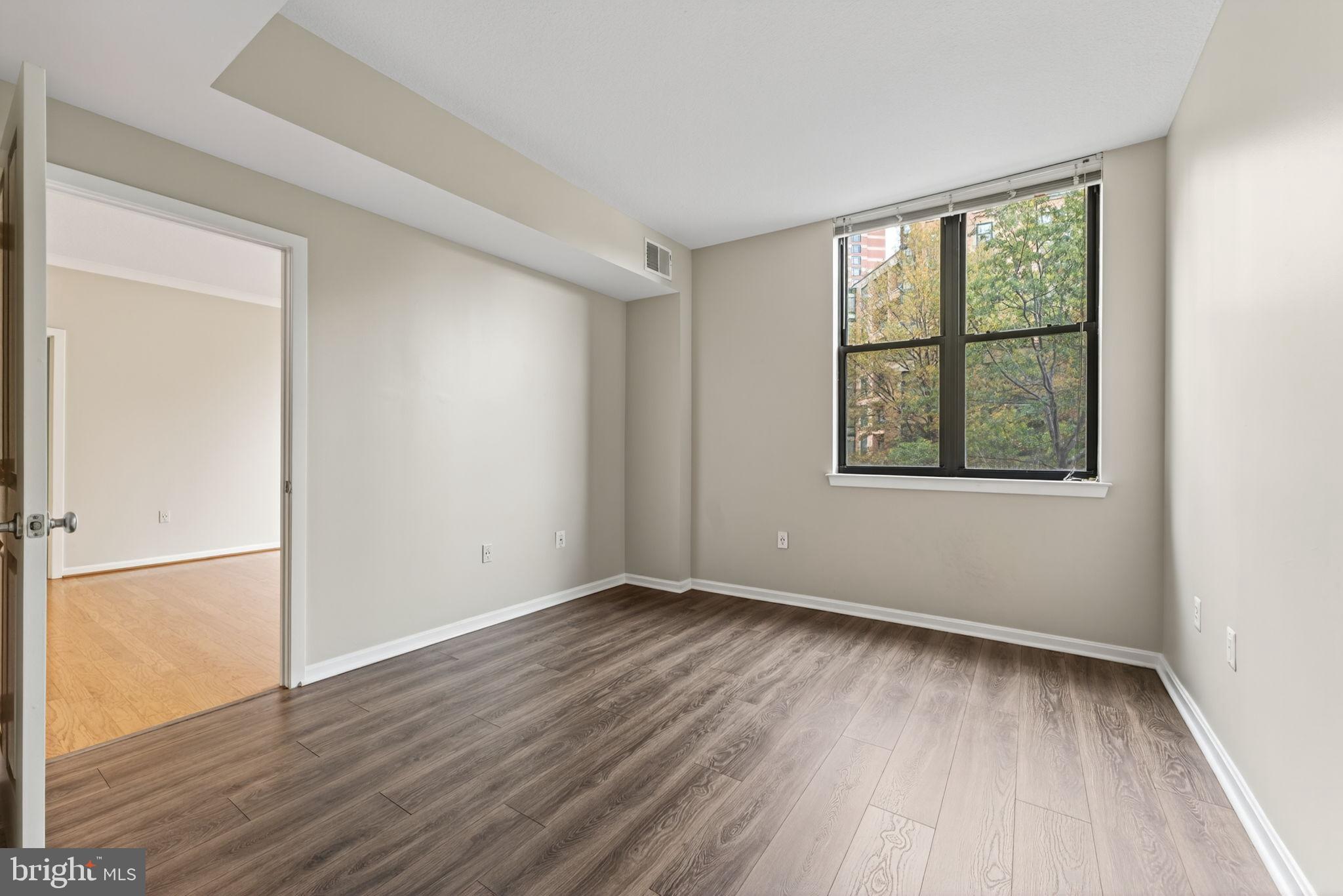 2220 Fairfax Drive, Unit 206 Arlington, VA 22201 - Photo 12 of 25 an empty room with wooden floor and windows