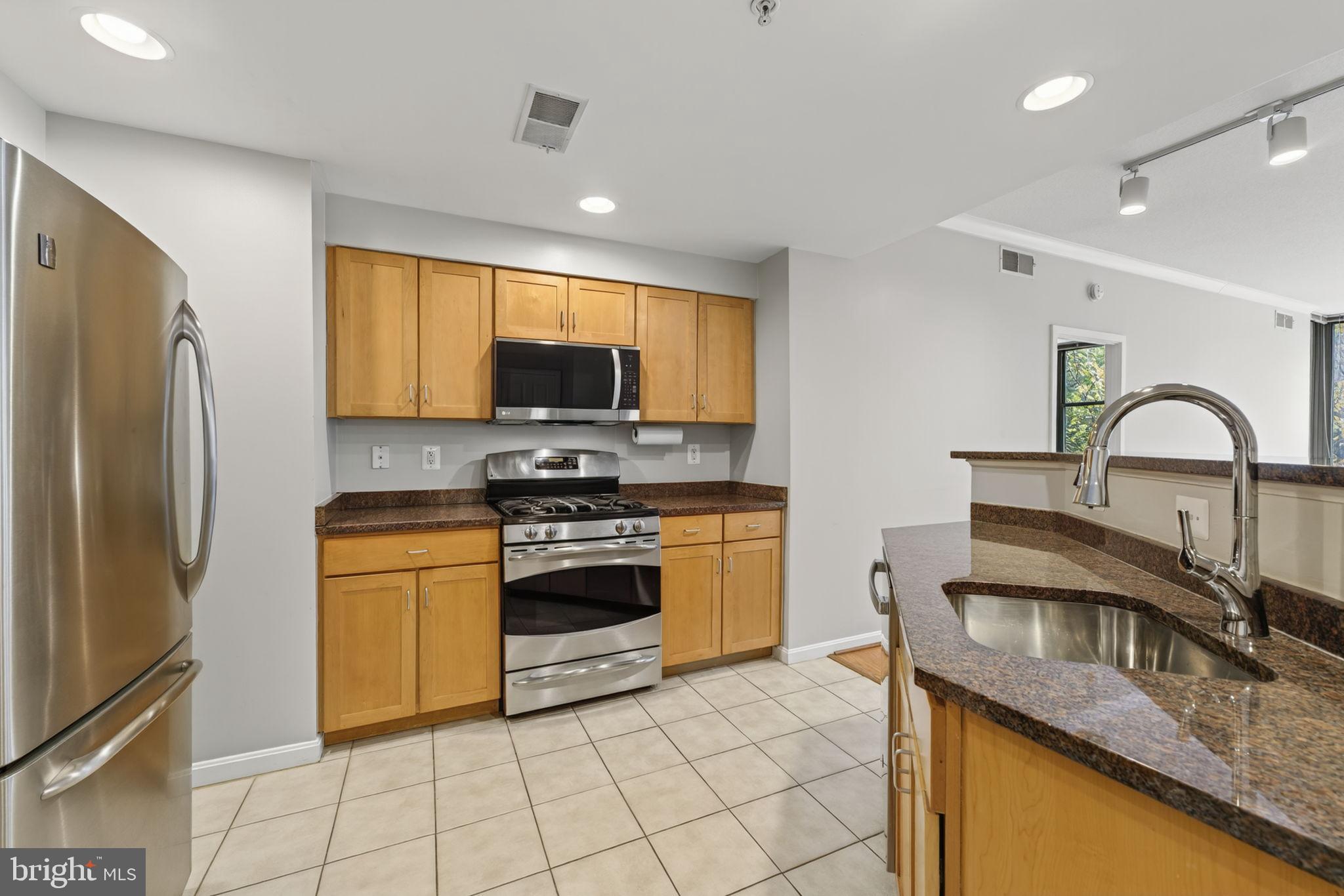 2220 Fairfax Drive, Unit 206 Arlington, VA 22201 - Photo 4 of 25 a kitchen with stainless steel appliances granite countertop a sink stove and refrigerator