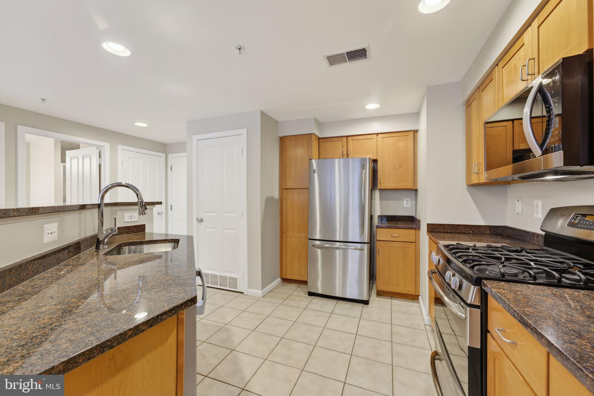 2220 Fairfax Drive, Unit 206 Arlington, VA 22201 - Photo 6 of 25 a kitchen with stainless steel appliances granite countertop a sink stove and refrigerator