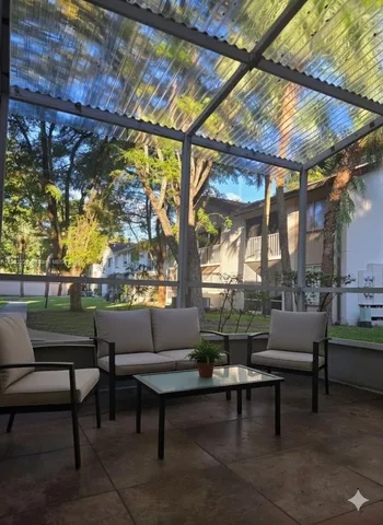 a view of a swimming pool with outdoor seating