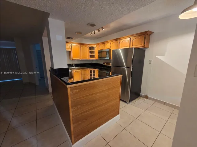 a kitchen with stainless steel appliances a refrigerator and a stove