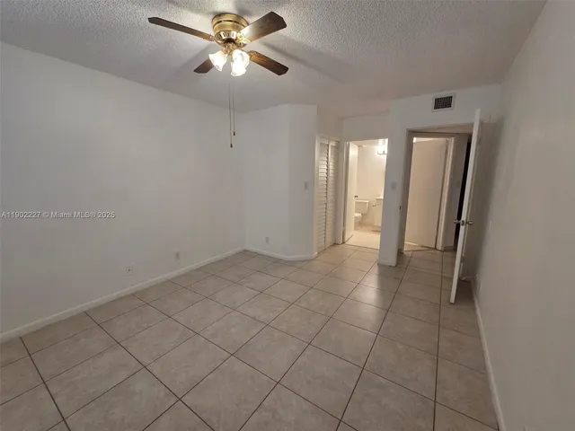 a view of a livingroom with a ceiling fan and window