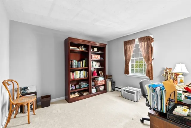 a view of a workspace with furniture and a window