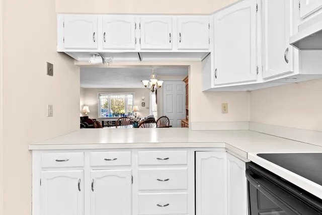 a kitchen with white cabinets and a sink
