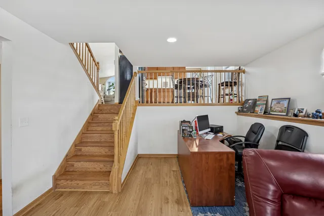 a workspace with wooden floor and windows