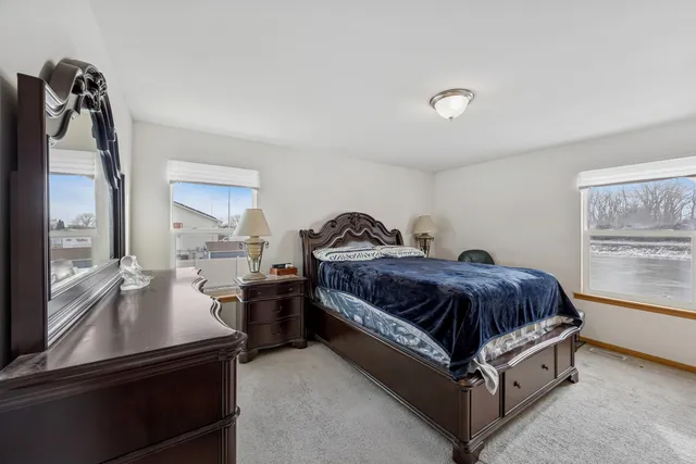 a spacious bedroom with a bed and window