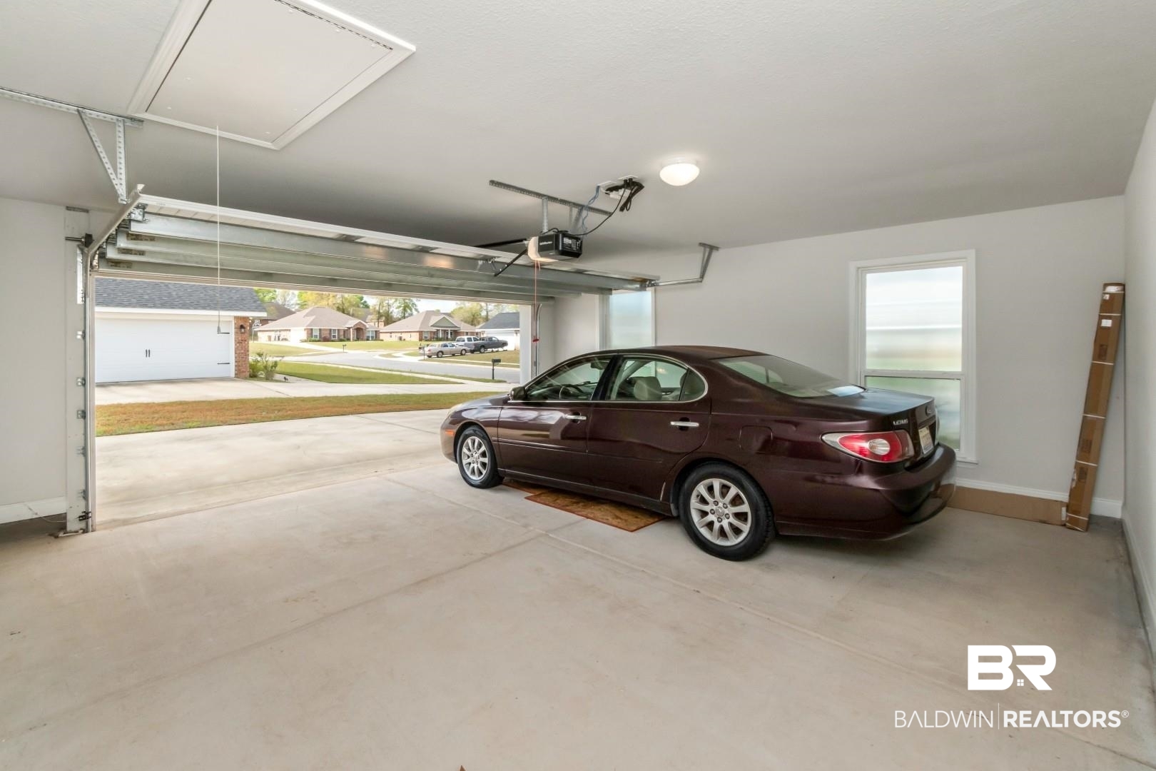 6632 Monarch Circle Mobile, AL 36618 - Photo 32 of 32 Garage with baseboards and a residential view