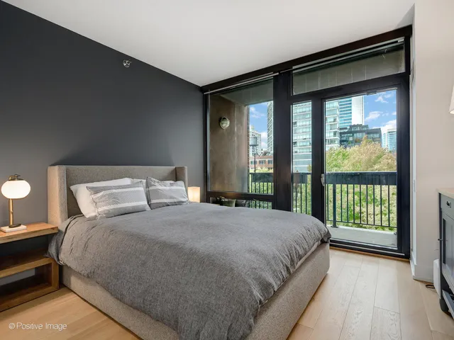 a bedroom with a large bed and a large window