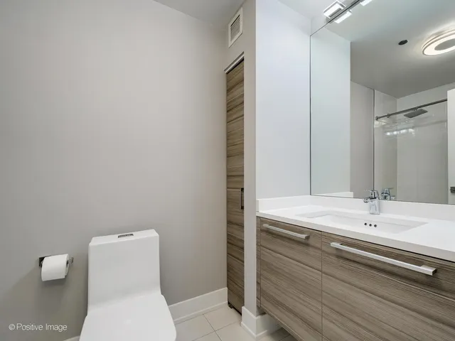 a bathroom with a sink a toilet and mirror