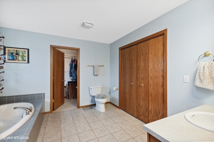 W6530 Barkers Road Elkhorn, WI 53121 - Photo 11 of 19 a bathroom with a sink a toilet and shower