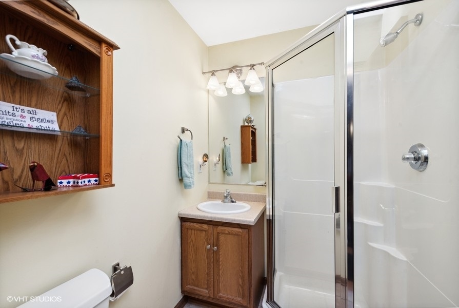 W6530 Barkers Road Elkhorn, WI 53121 - Photo 15 of 19 a bathroom with a sink mirror and a shower