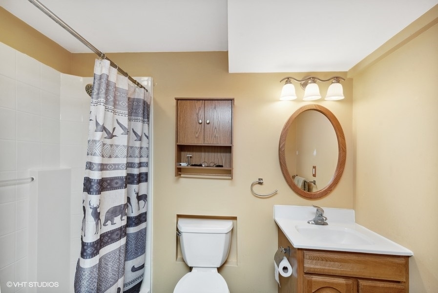 W6530 Barkers Road Elkhorn, WI 53121 - Photo 16 of 19 a bathroom with a sink mirror and toilet