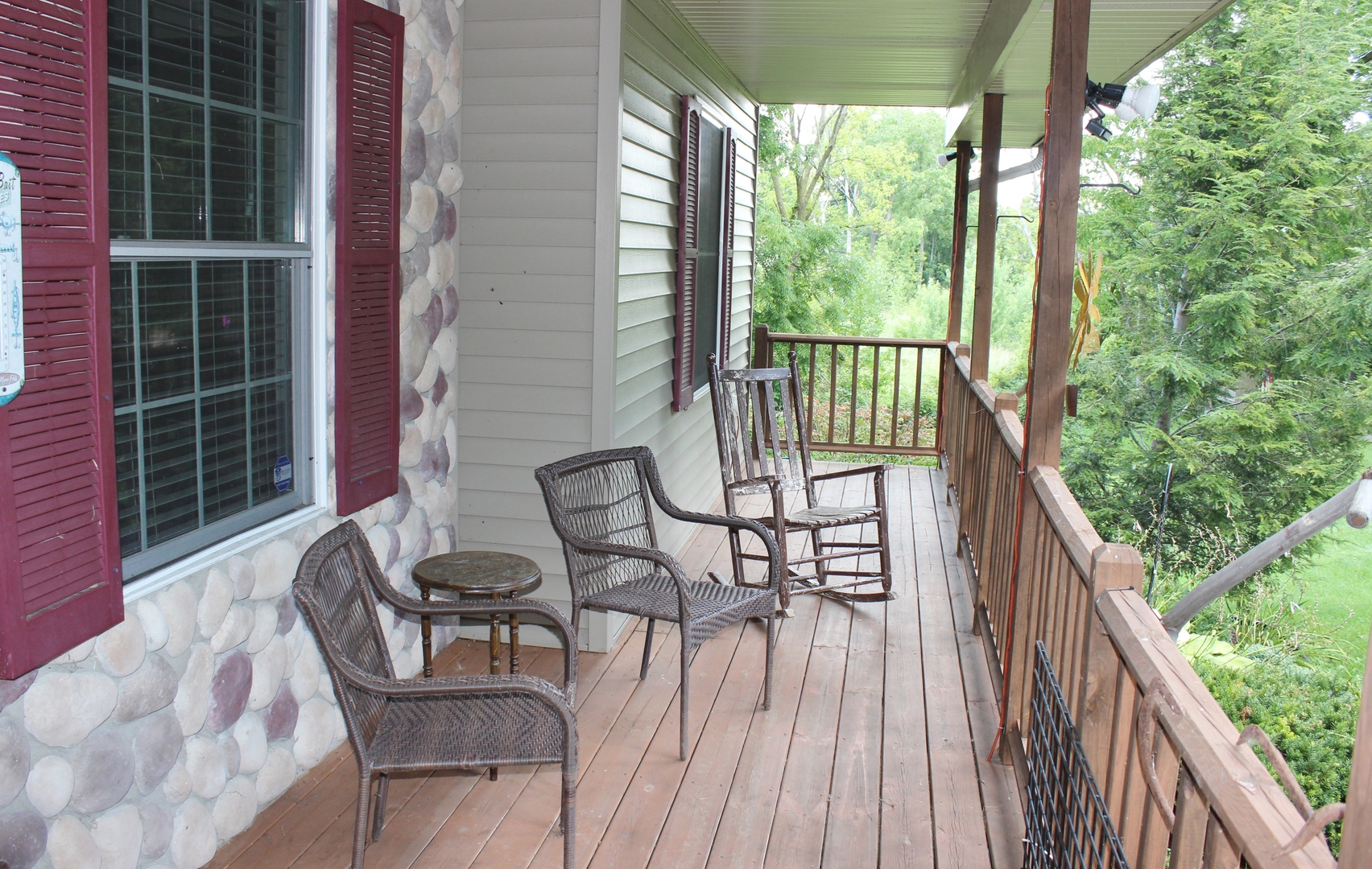 W6530 Barkers Road Elkhorn, WI 53121 - Photo 3 of 19 a porch with a bench next to a yard