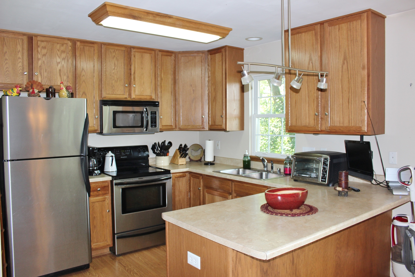 W6530 Barkers Road Elkhorn, WI 53121 - Photo 6 of 19 a kitchen with a sink a stove and refrigerator