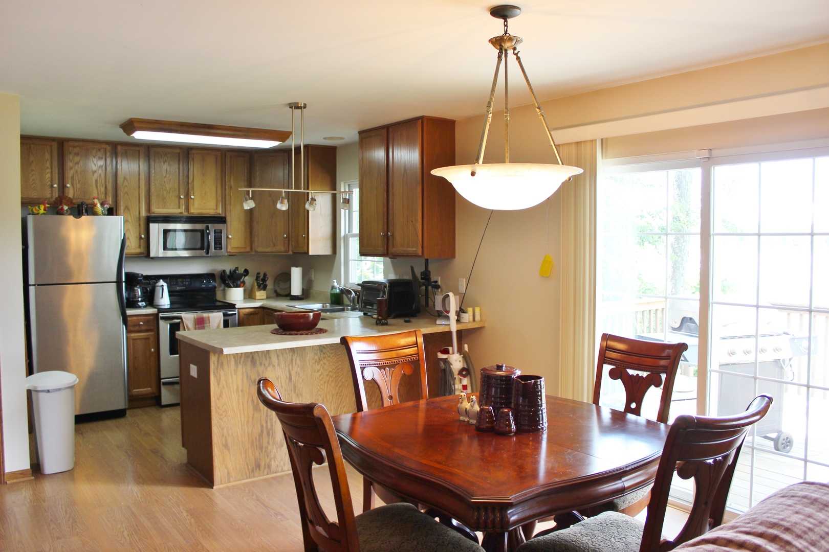 W6530 Barkers Road Elkhorn, WI 53121 - Photo 7 of 19 a dining room with furniture a chandelier and wooden floor
