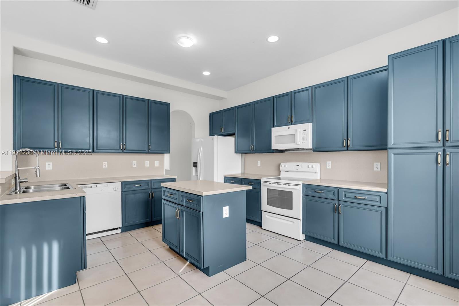8920 Northwest 180th Terrace Hialeah, FL 33018 - Photo 12 of 44 a kitchen with stainless steel appliances granite countertop wooden cabinets and sink