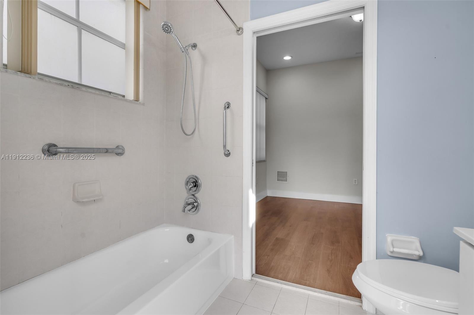 8920 Northwest 180th Terrace Hialeah, FL 33018 - Photo 17 of 44 a bathroom with a bathtub and a shower