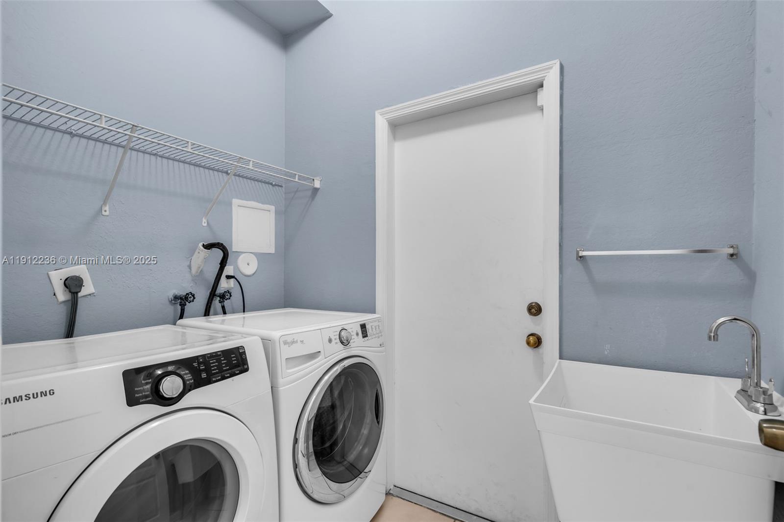 8920 Northwest 180th Terrace Hialeah, FL 33018 - Photo 20 of 44 a utility room with dryer and washer