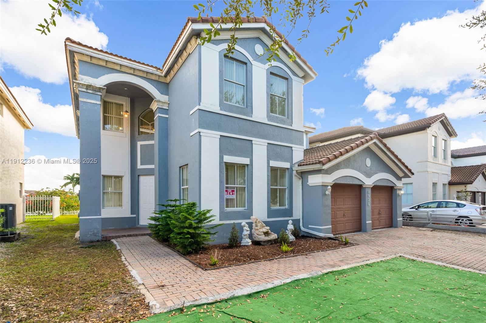 8920 Northwest 180th Terrace Hialeah, FL 33018 - Photo 2 of 44 a front view of a house with garden