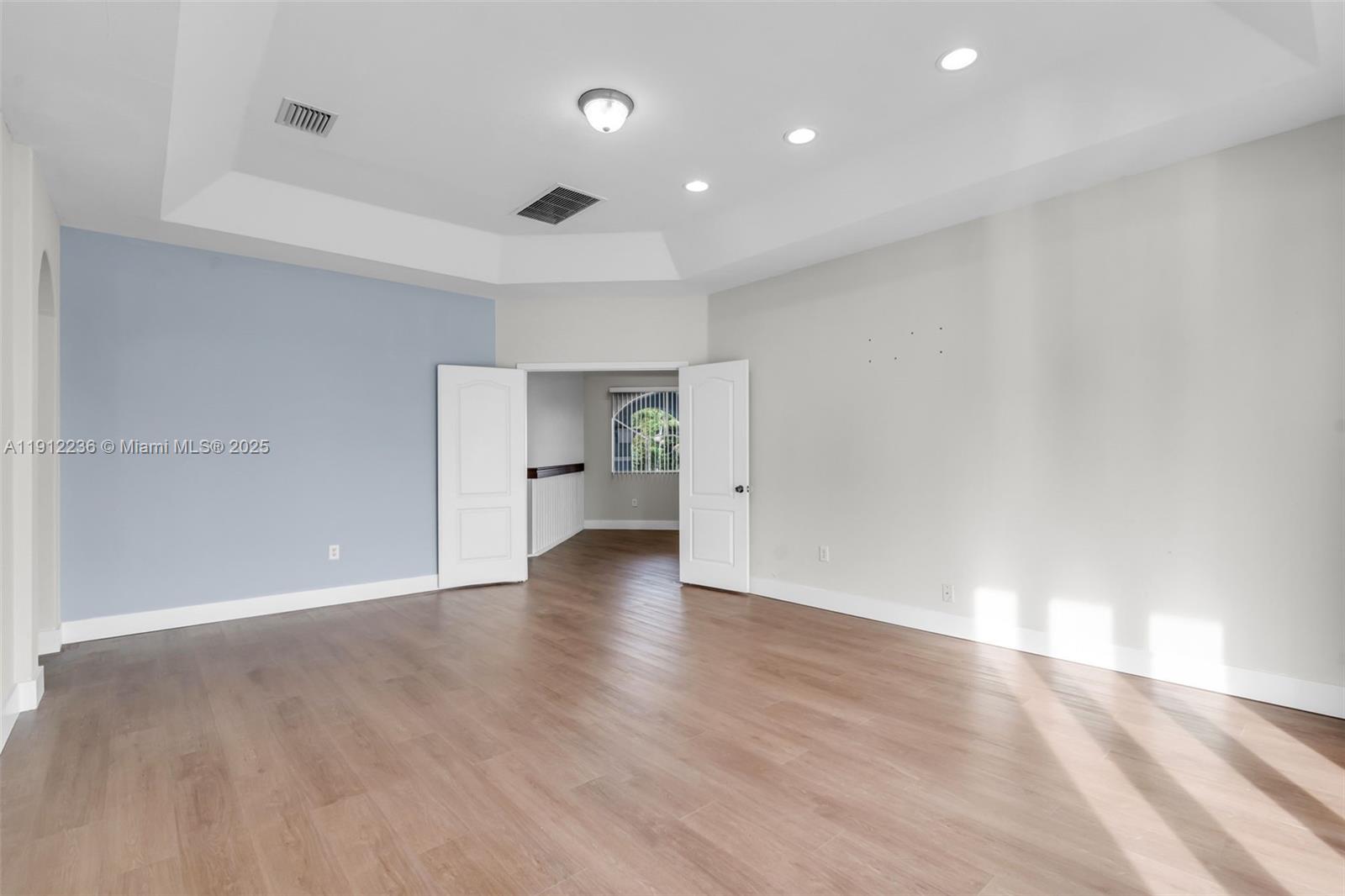 8920 Northwest 180th Terrace Hialeah, FL 33018 - Photo 23 of 44 a view of empty room with wooden floor and window