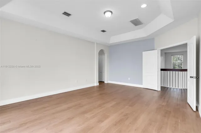 a bathroom with a granite countertop double vanity sink a mirror and a bathtub