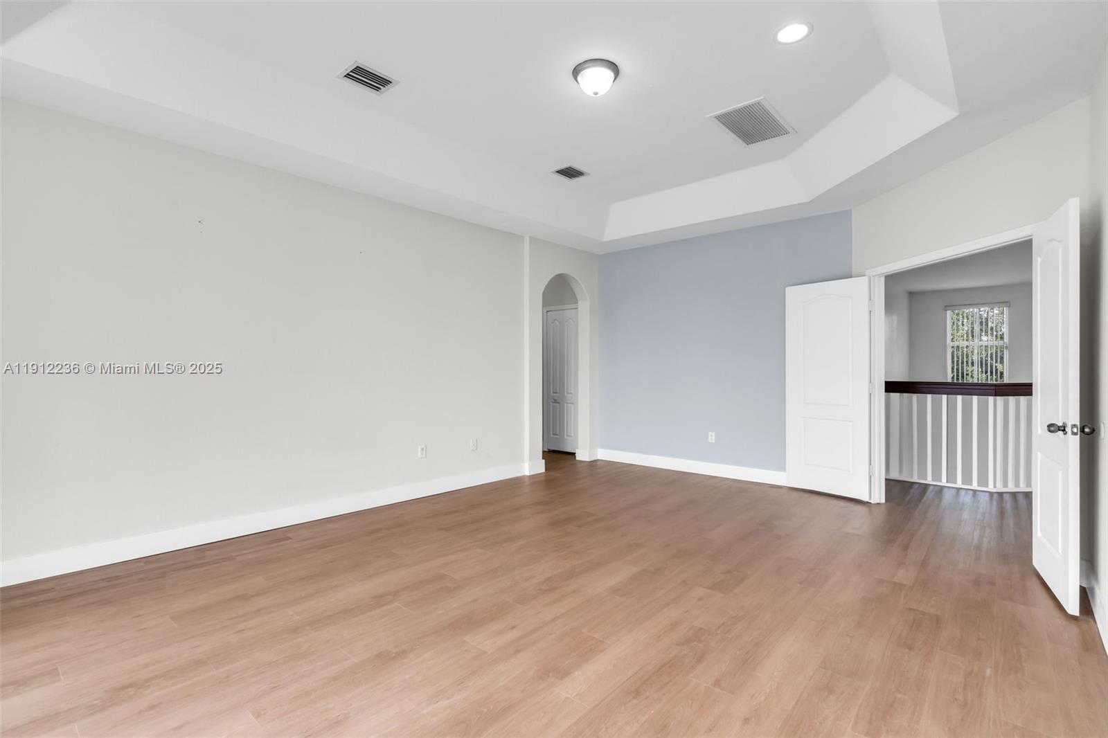8920 Northwest 180th Terrace Hialeah, FL 33018 - Photo 24 of 44 a view of an empty room with wooden floor and window
