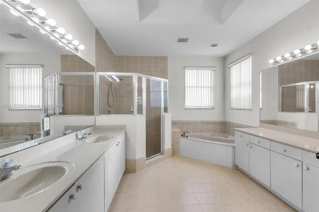 a bathroom with a double vanity sink and a mirror