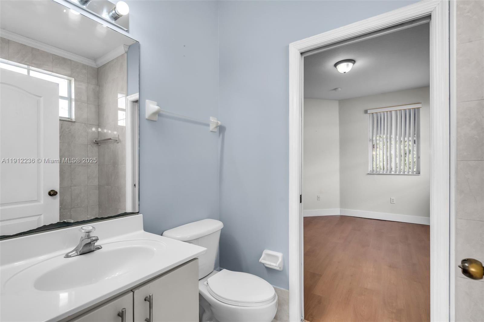 8920 Northwest 180th Terrace Hialeah, FL 33018 - Photo 33 of 44 a bathroom with a sink a toilet and shower