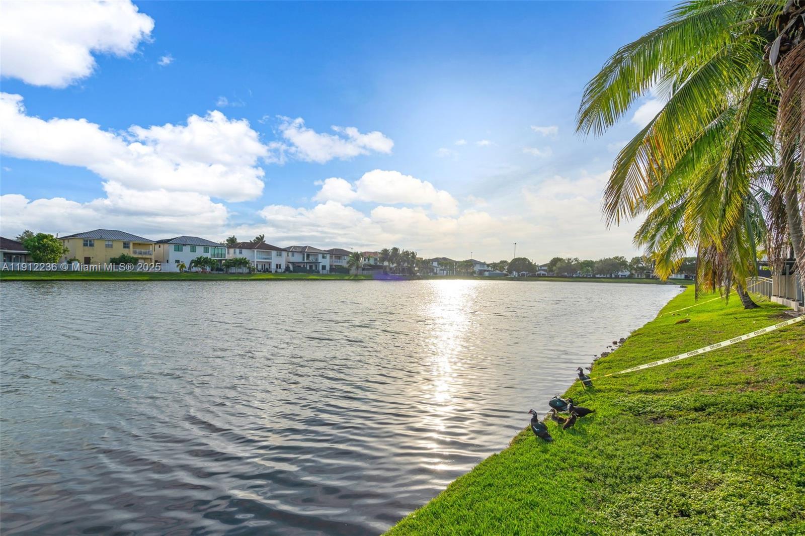 8920 Northwest 180th Terrace Hialeah, FL 33018 - Photo 38 of 44 a view of a lake with a big yard