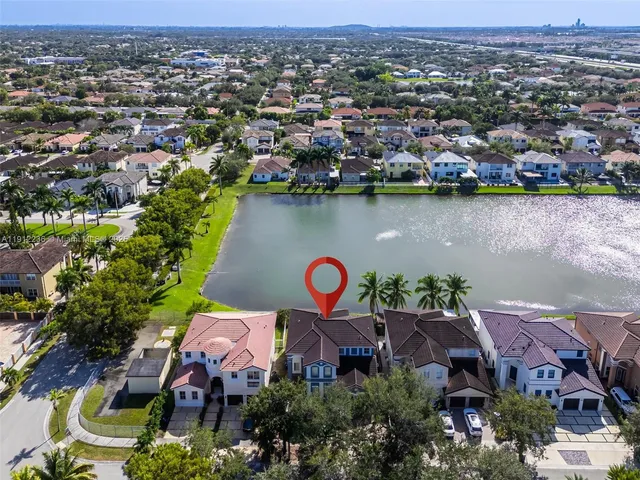 an aerial view of residential houses with outdoor space and swimming pool