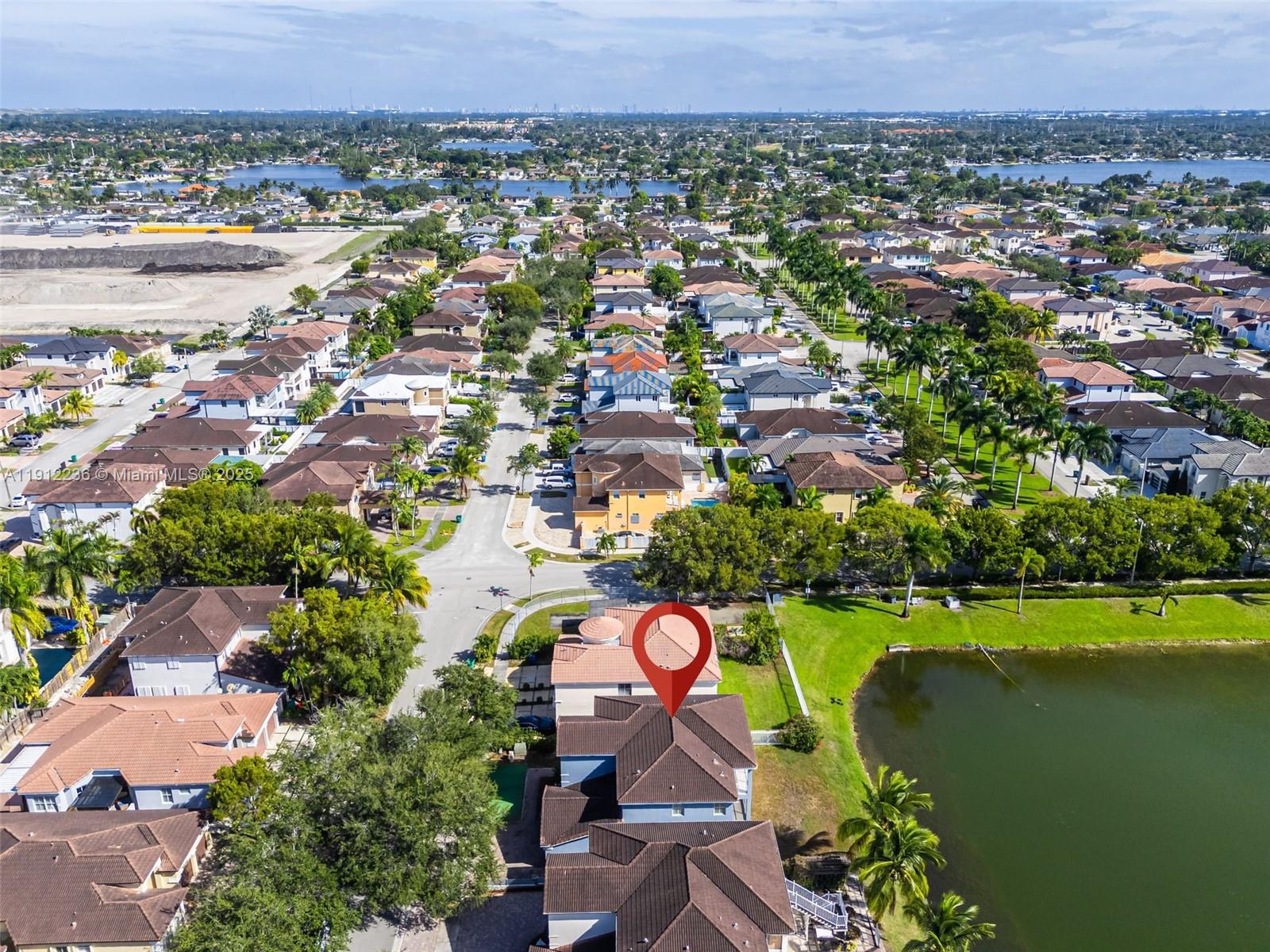 8920 Northwest 180th Terrace Hialeah, FL 33018 - Photo 40 of 44 an aerial view of a house with a garden and lake view
