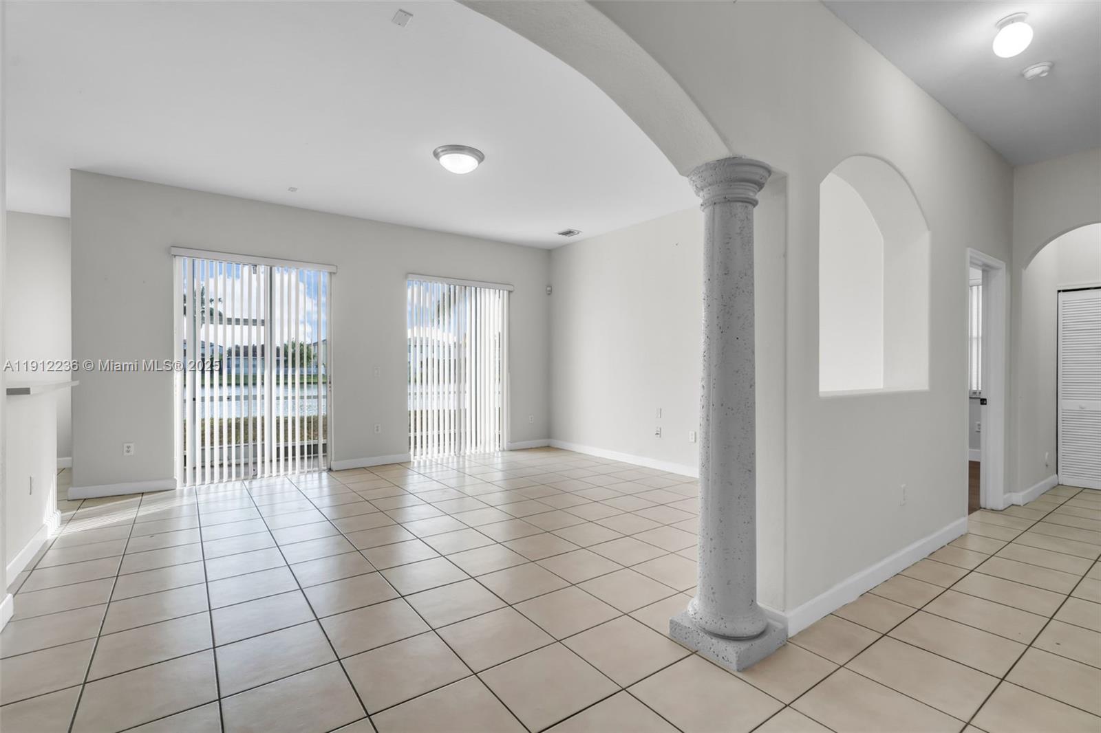 8920 Northwest 180th Terrace Hialeah, FL 33018 - Photo 4 of 44 a view of an empty room and window