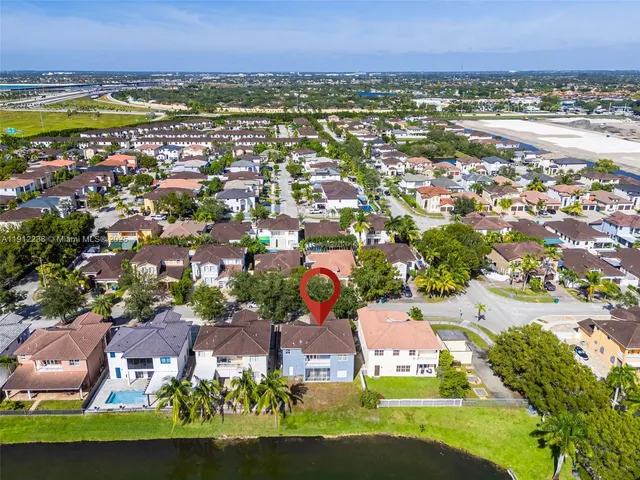 an aerial view of a house with a yard